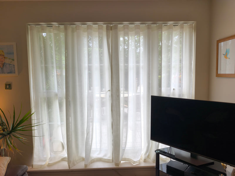 Silent Gliss 6010 curtain track in white, ceiling fixed, with Wave sheer curtains in a customer's living room