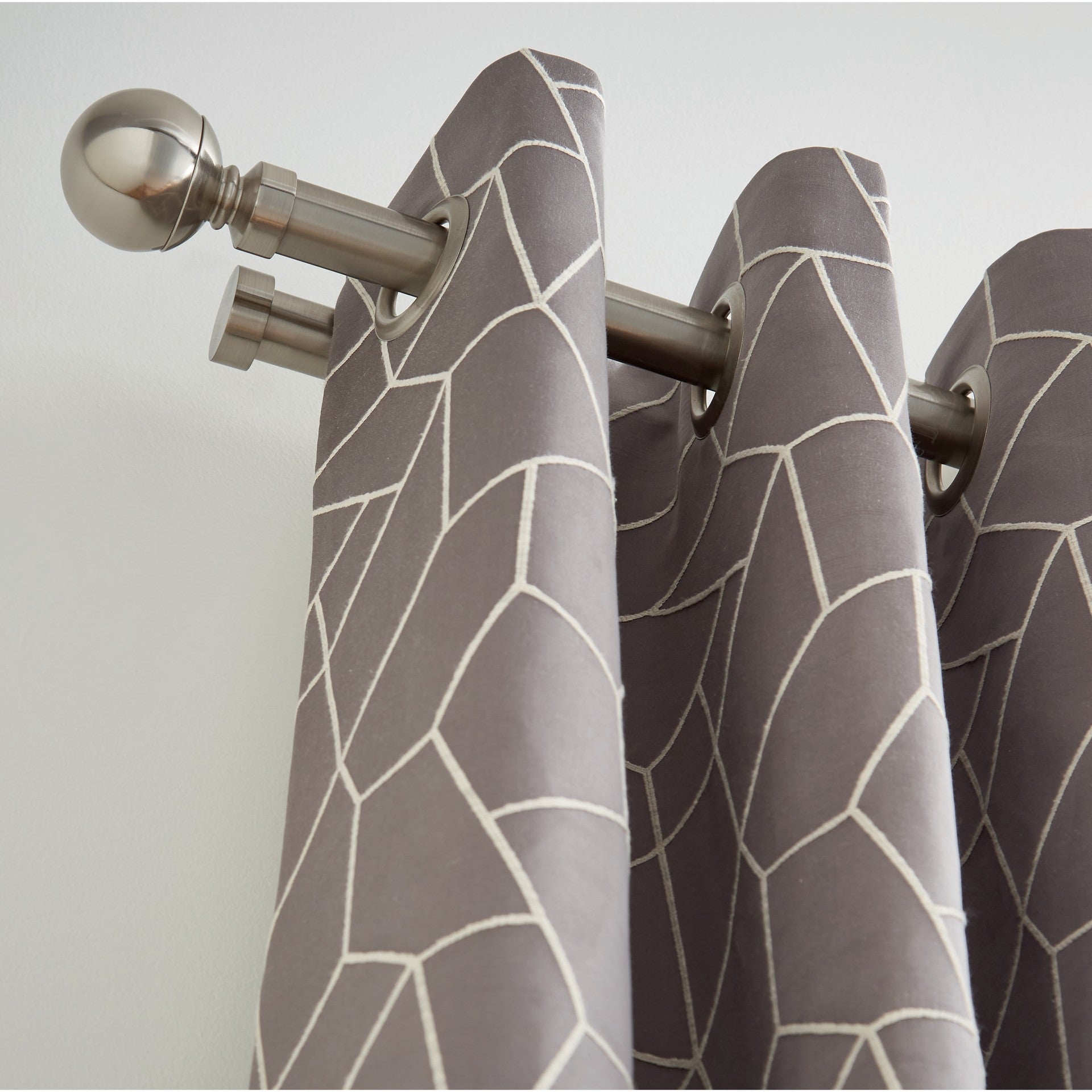 Hallis Neo double curtain pole close up: 28mm front pole with Ball finial and eyelet curtain, 19mm voile pole behind